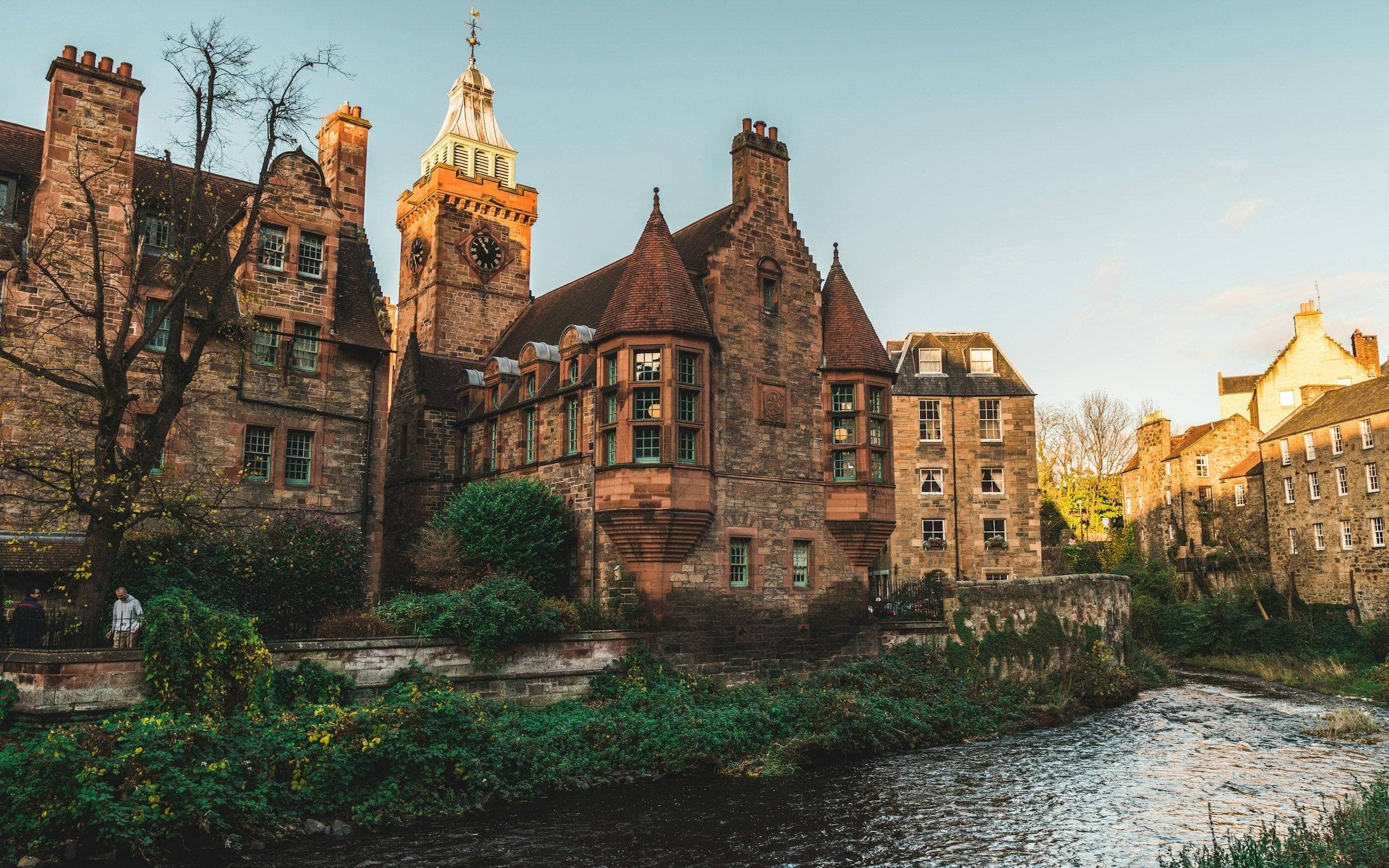 Well Court's red sandstone and clock tower beside the Water of Leith in Dean Village, Edinburgh