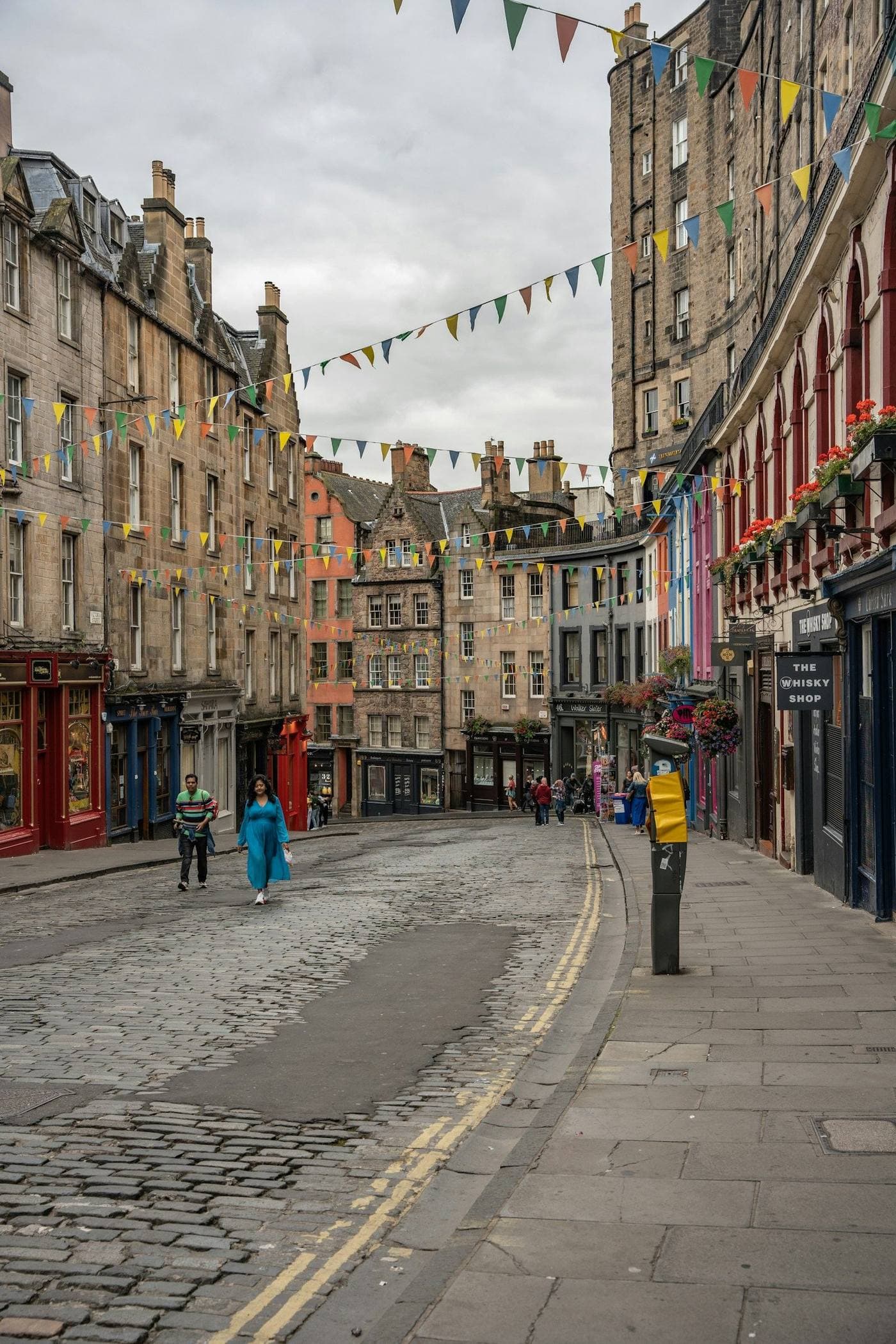 Colourful shopfronts curving down Victoria Street in Edinburgh's Old Town